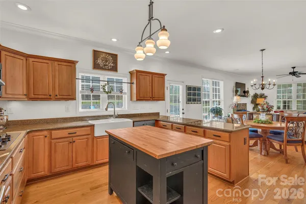 a kitchen with a stove window and cabinets