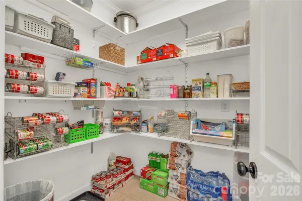 a store room with lots of clutter and refrigerator