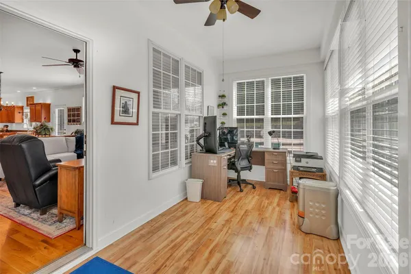 a view of a workspace with furniture and a window