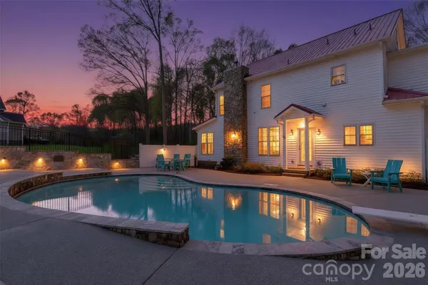a view of swimming pool with a outdoor seating