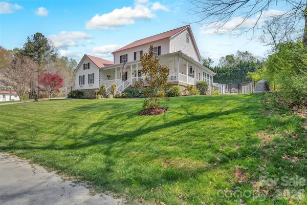 a view of a house with a yard and sitting area