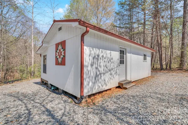 a view of a house with a yard and wooden fence
