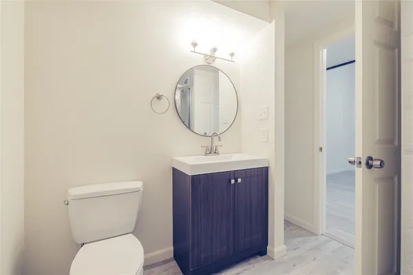 a bathroom with a toilet a sink and mirror