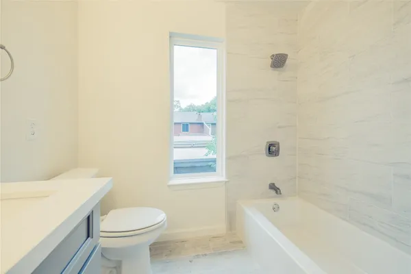 a bathroom with a sink a toilet and bathtub