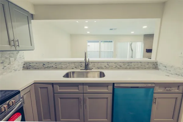 a kitchen with a sink and cabinets