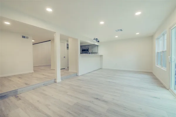 an empty room with a empty space and windows