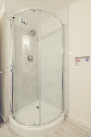 a bathroom with a glass shower door