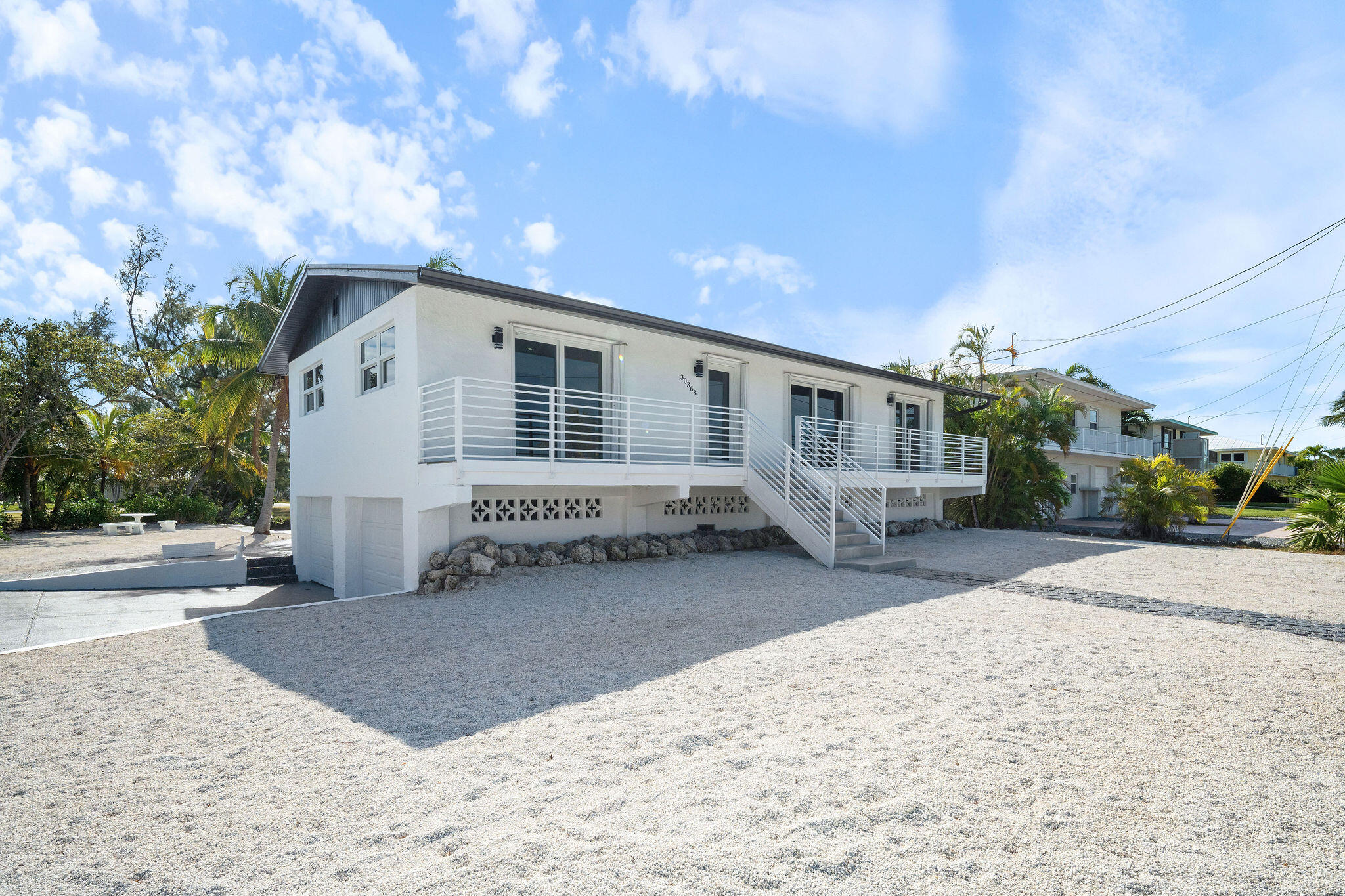 30368 Killdeer Lane Big Pine Key, FL 33043 - Photo 11 of 59 a front view of a house with a yard and garage