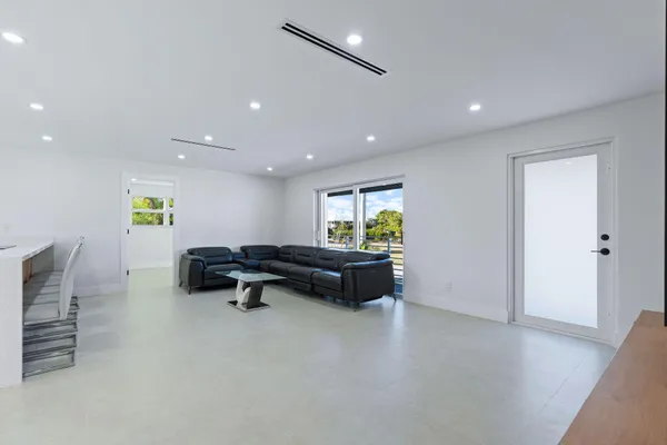 a large white kitchen with a large window