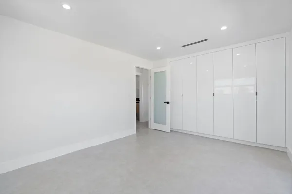 a white house with tree in front of it