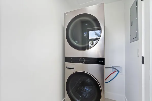 a view of a house with a yard and palm trees