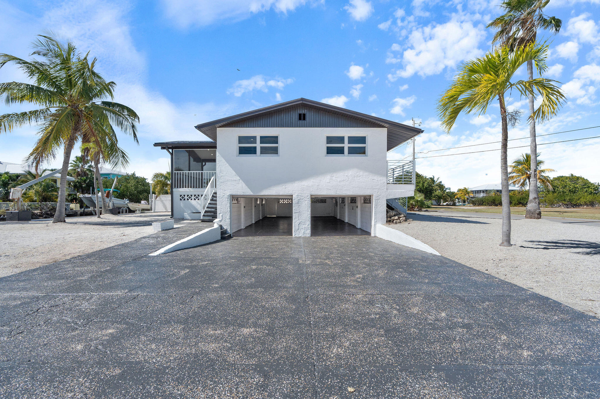 30368 Killdeer Lane Big Pine Key, FL 33043 - Photo 53 of 59 a view of a house with a yard and palm trees