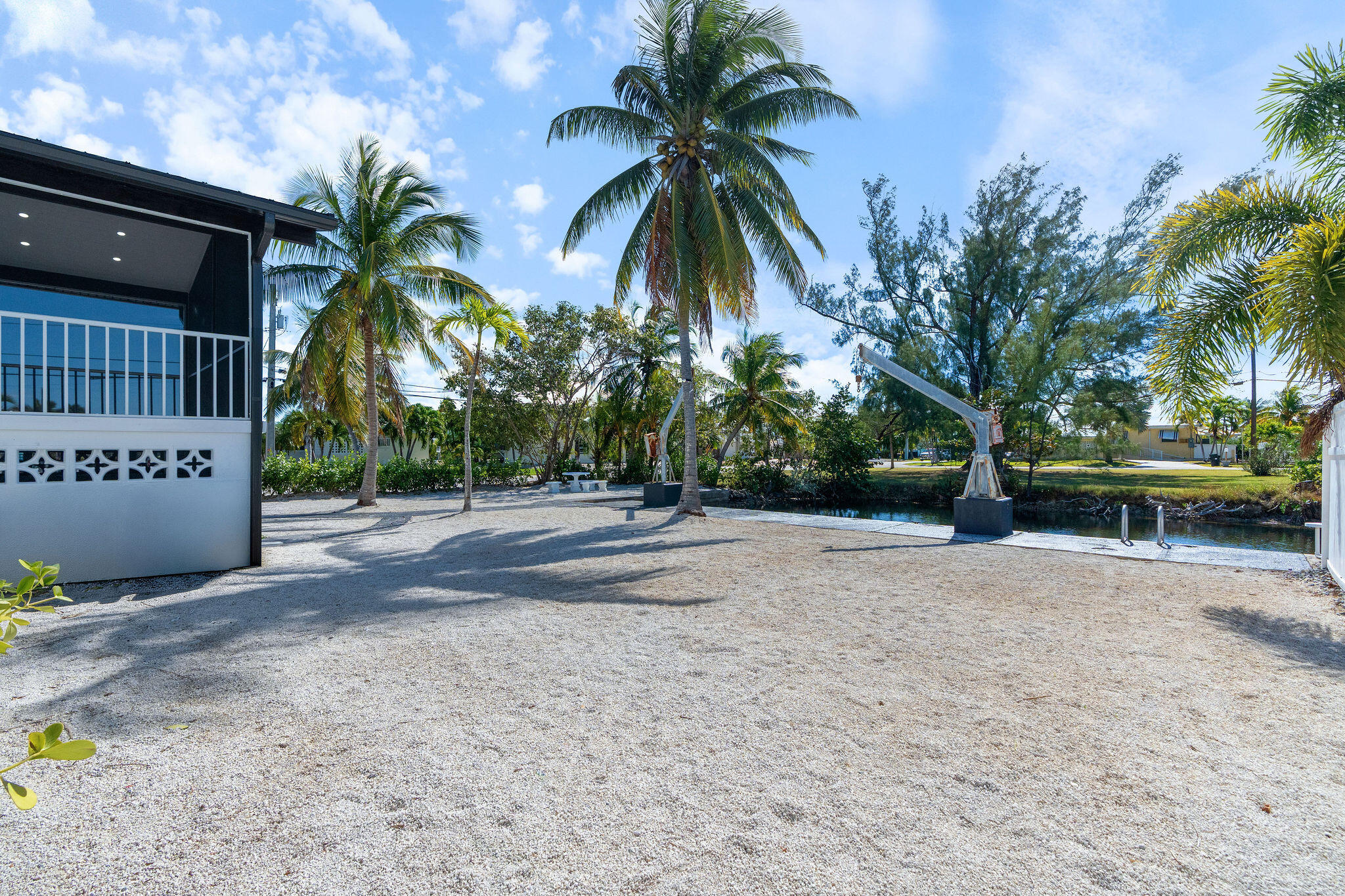 30368 Killdeer Lane Big Pine Key, FL 33043 - Photo 58 of 59 a view of a house with a yard and palm trees