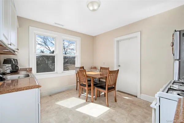 a dining room with furniture and window