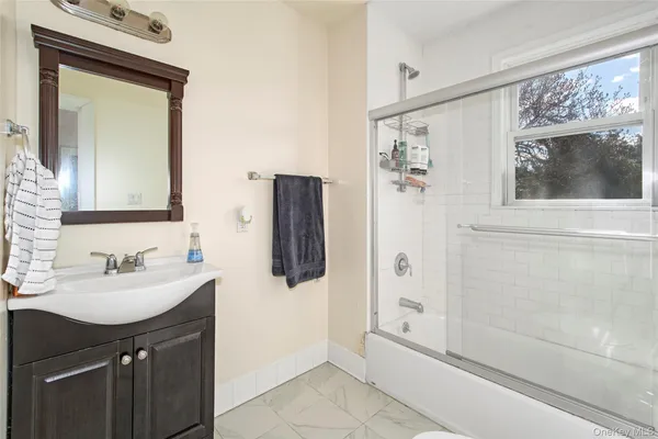 a bathroom with a sink a mirror and a shower
