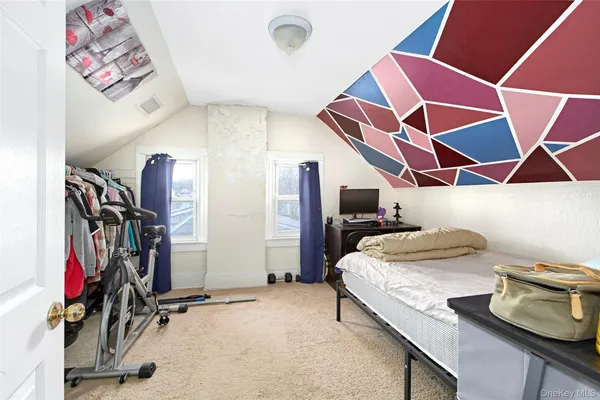 a room with gym equipment and mirrors
