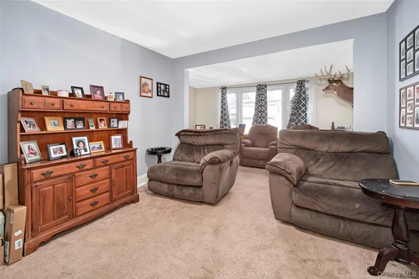 a living room with furniture cabinets and a window
