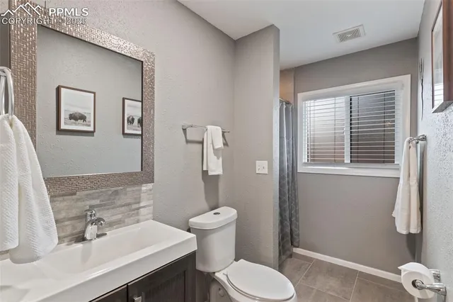 a bathroom with a sink toilet and mirror