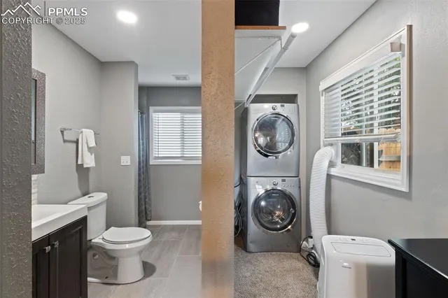 a bathroom with a toilet and a washing machine