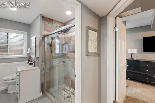 a bathroom with a toilet a sink and a mirror