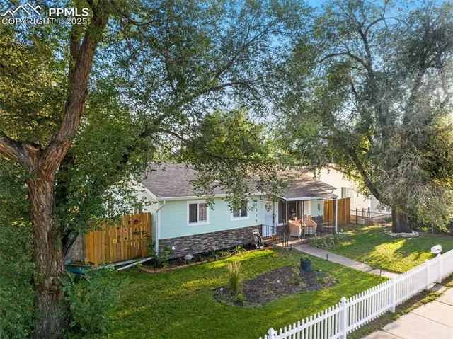 a view of house with backyard and swimming pool