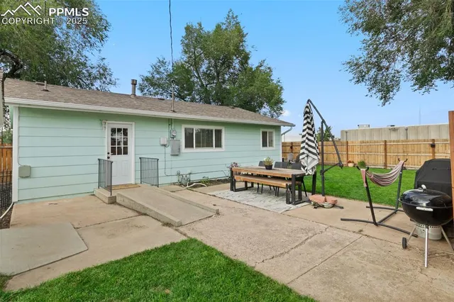 a view of a patio with table and chairs and potted plants