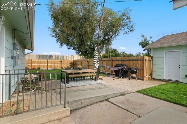 a view of backyard with wheel chair and potted plants