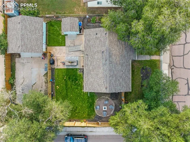 an aerial view of a house with garden space and street view