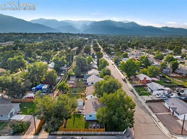 an aerial view of residential house and car parked