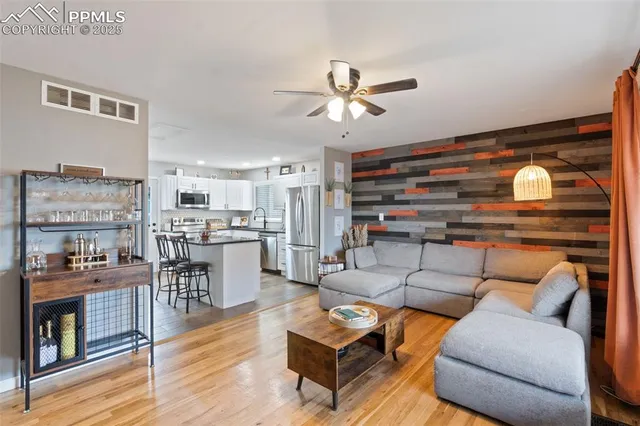 a living room with furniture and kitchen view