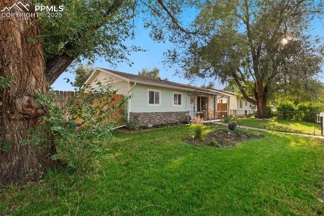 a view of a house with backyard and sitting area