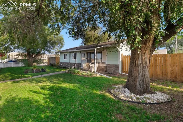 a front view of a house with a yard garden and patio