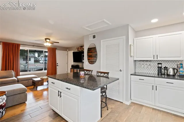 a kitchen with stainless steel appliances granite countertop a sink stove and wooden cabinets