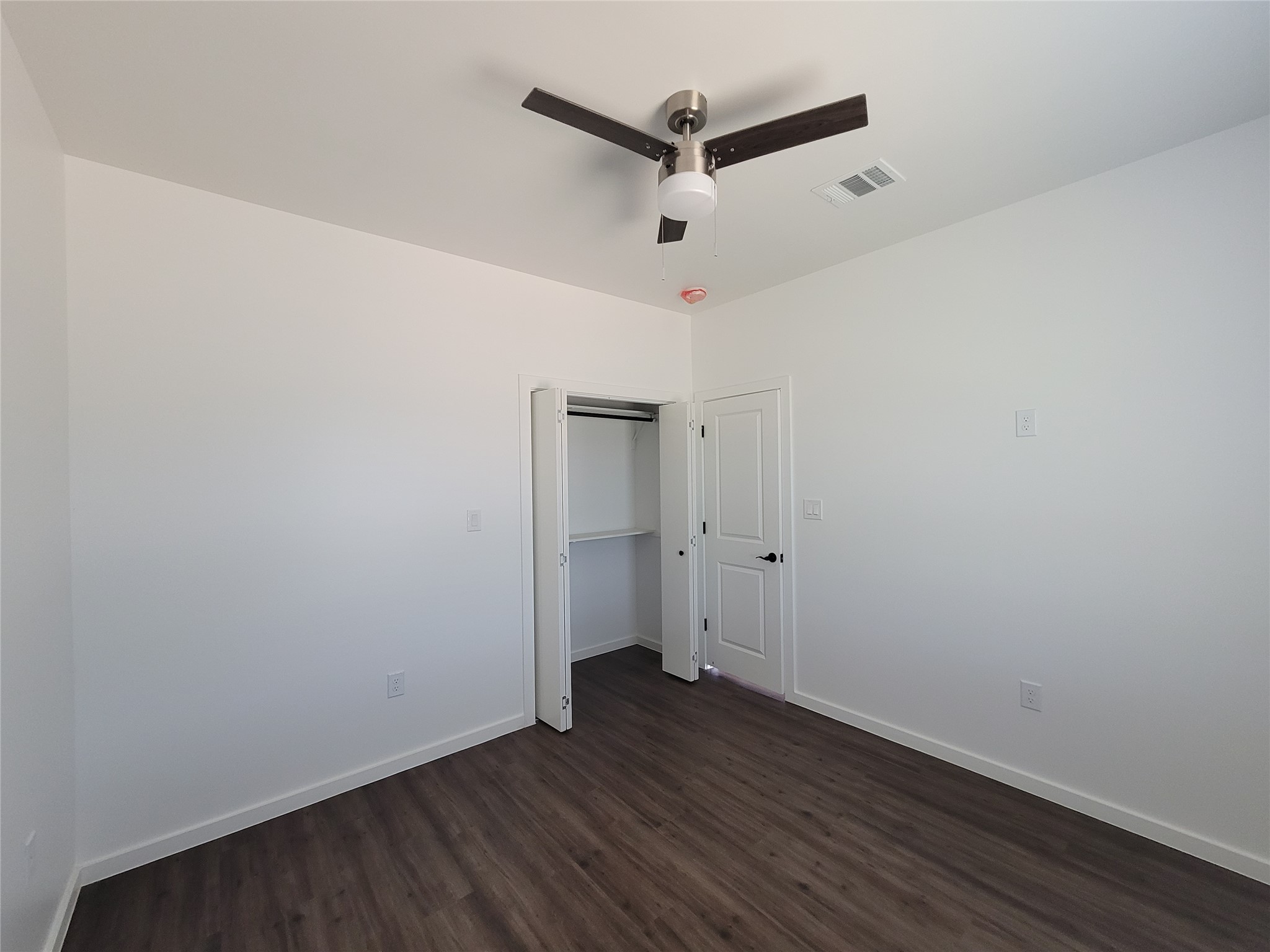 422 A Road Stockdale, TX 78160 - Photo 31 of 40 A well-proportioned bedroom with rich hardwood-style flooring and a contemporary ceiling fan awaits.