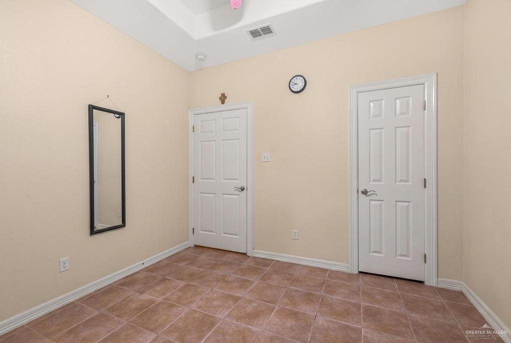 605 South Whalen Road Donna, TX 78537 - Photo 13 of 21 Bathroom featuring a built-in soaking tub with tile surround, a separate glass-enclosed shower, a double vanity with a laminate countertop, and neutral tile flooring