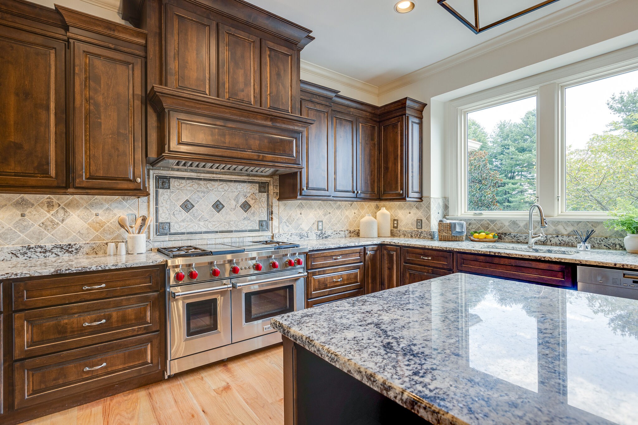 9501 Clovercroft Road Franklin, TN 37067 - Photo 29 of 70 a kitchen with stainless steel appliances granite countertop a stove a sink and a microwave