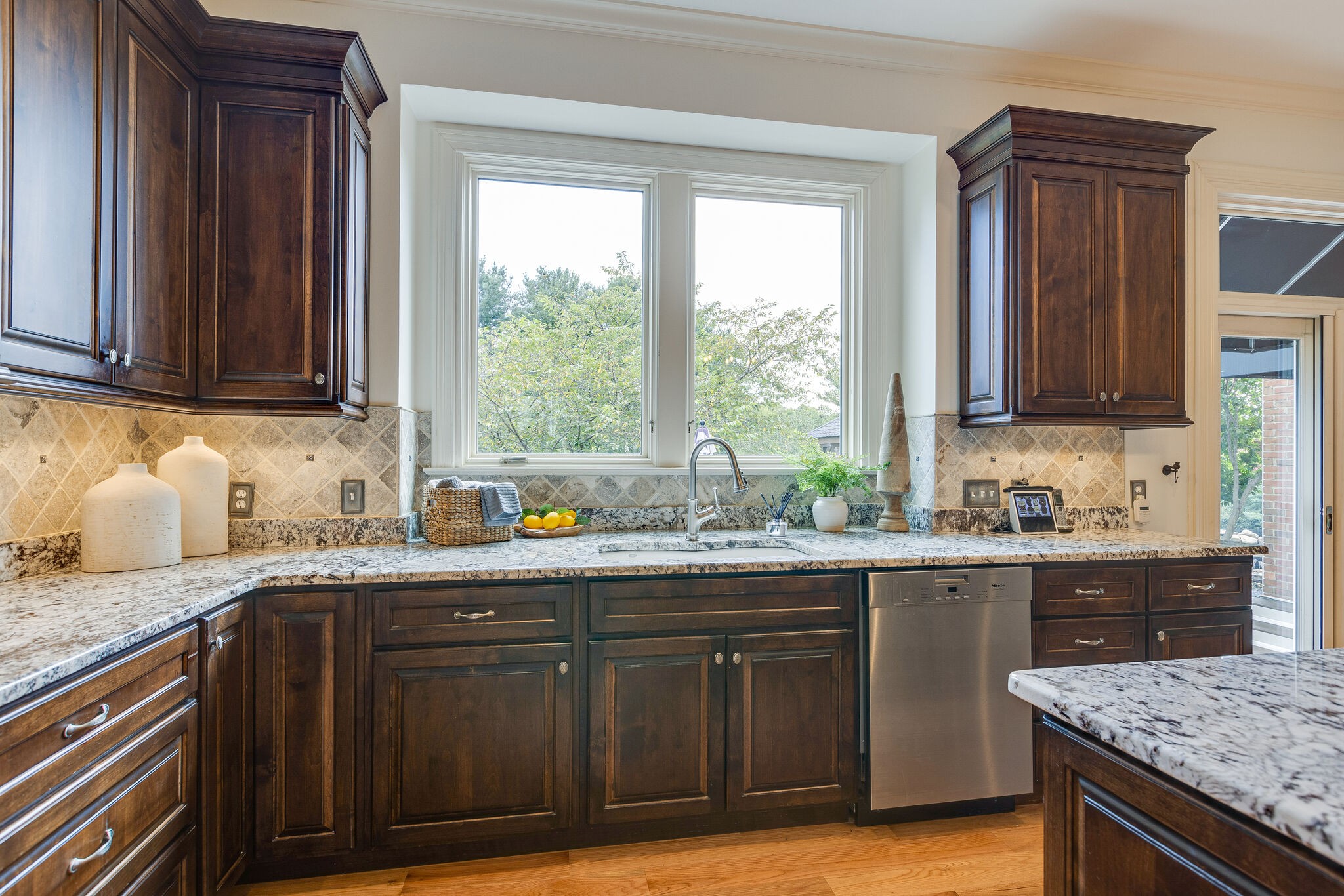 9501 Clovercroft Road Franklin, TN 37067 - Photo 30 of 70 a kitchen with stainless steel appliances granite countertop wooden cabinets a sink and dishwasher with wooden floor
