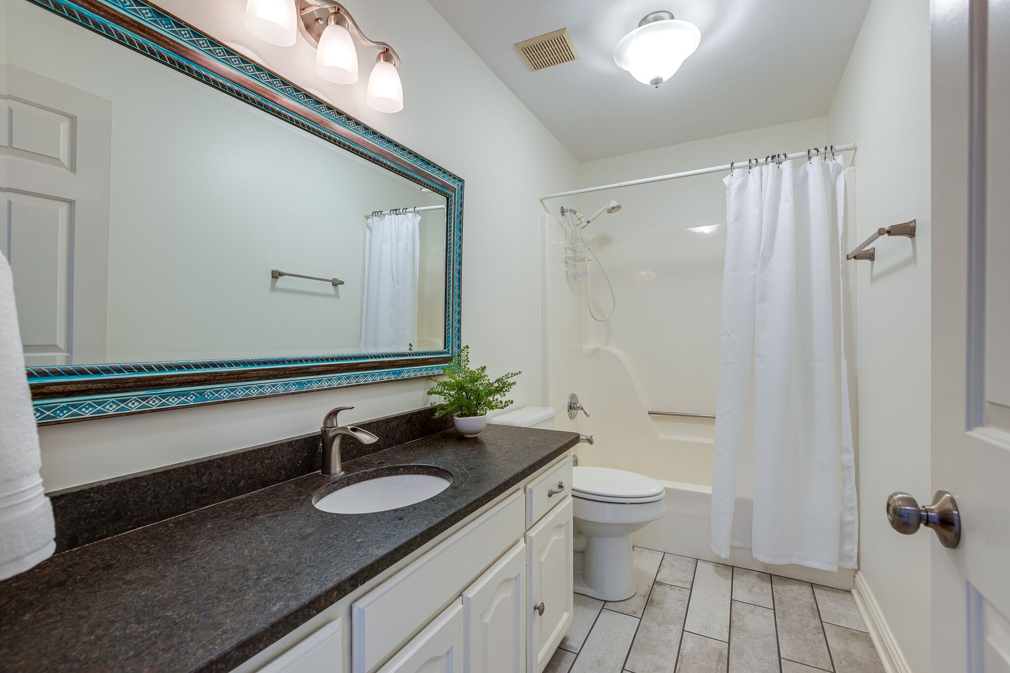 9501 Clovercroft Road Franklin, TN 37067 - Photo 46 of 70 a bathroom with a sink a toilet a mirror and shower