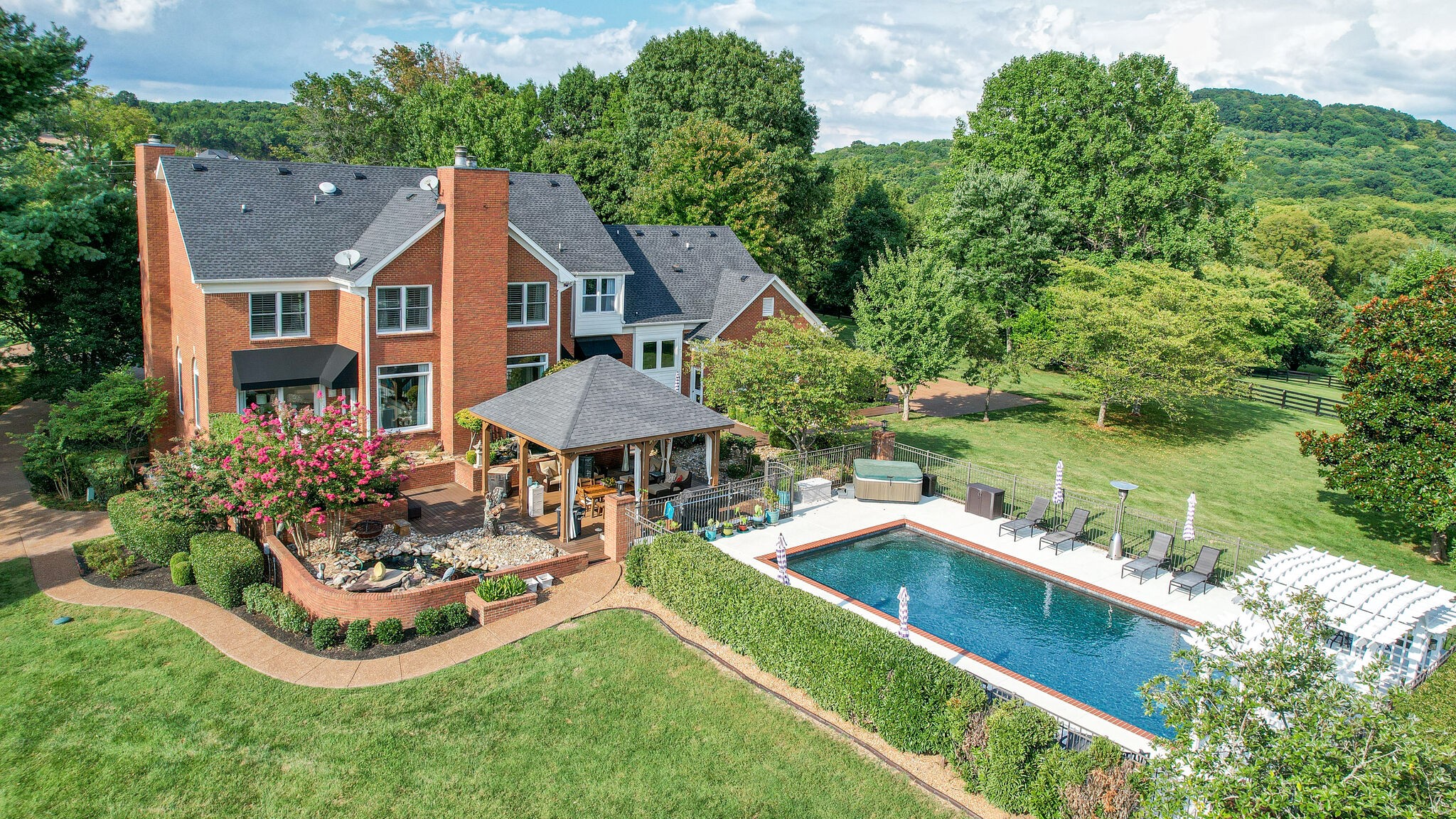 9501 Clovercroft Road Franklin, TN 37067 - Photo 63 of 70 a aerial view of a house with swimming pool and a garden