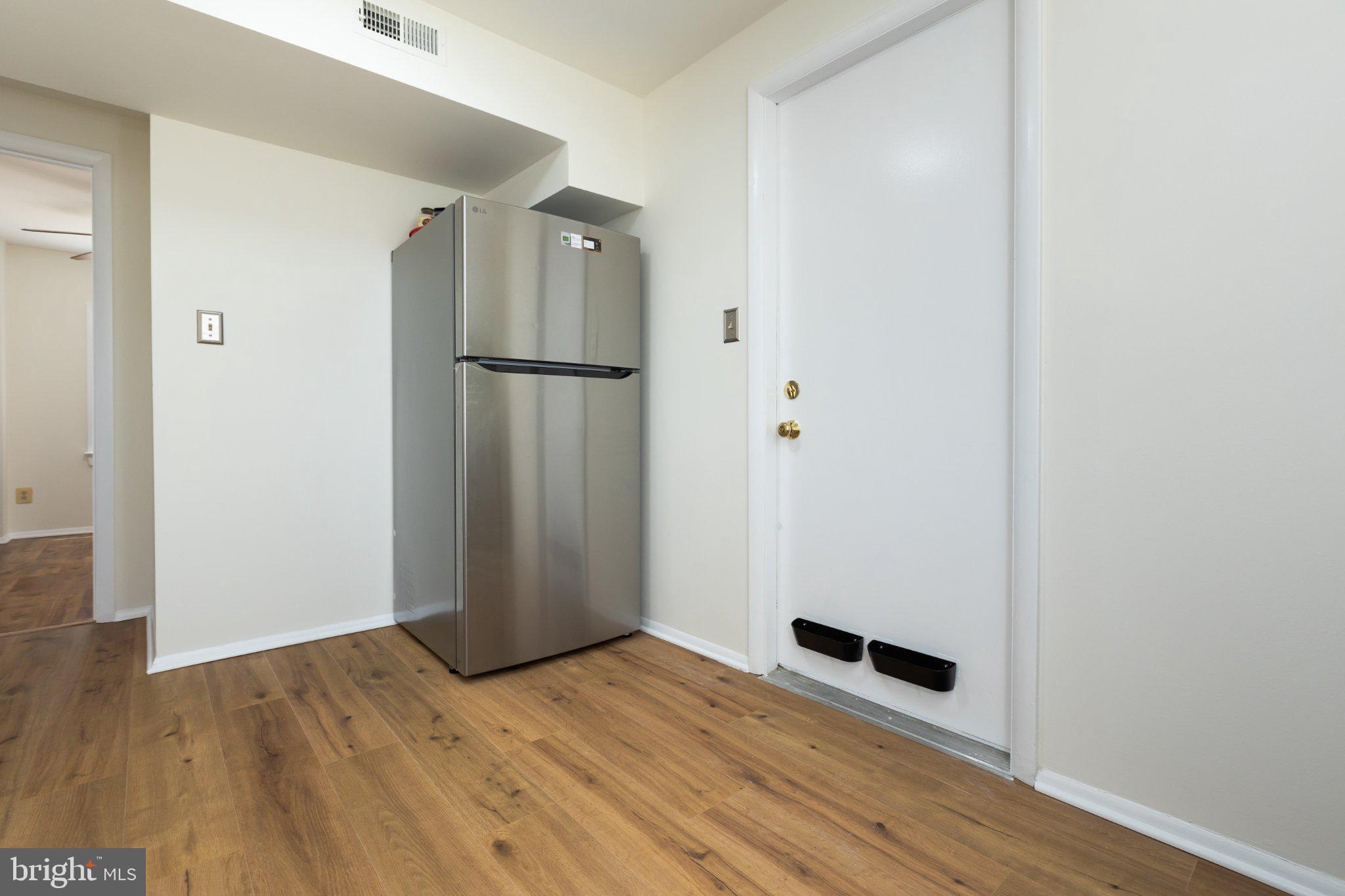3613 Rusty Rim Ellicott City, MD 21043 - Photo 27 of 39 Modern kitchen entryway with sleek fridge.