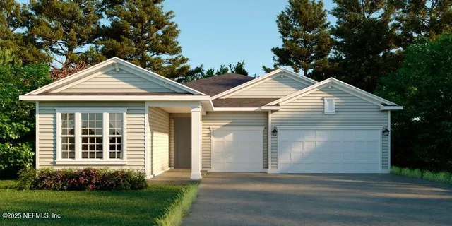 a front view of a house with a garden and yard
