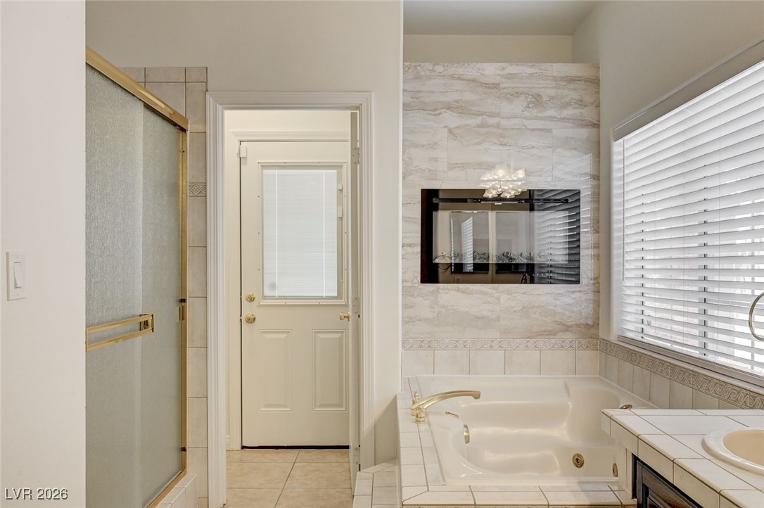2955 El Camino Road Las Vegas, NV 89146 - Photo 56 of 99 Bathroom with a tub with jets, a shower stall, and vanity