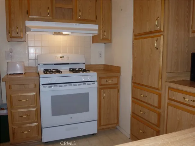 a kitchen with cabinets appliances and a counter space
