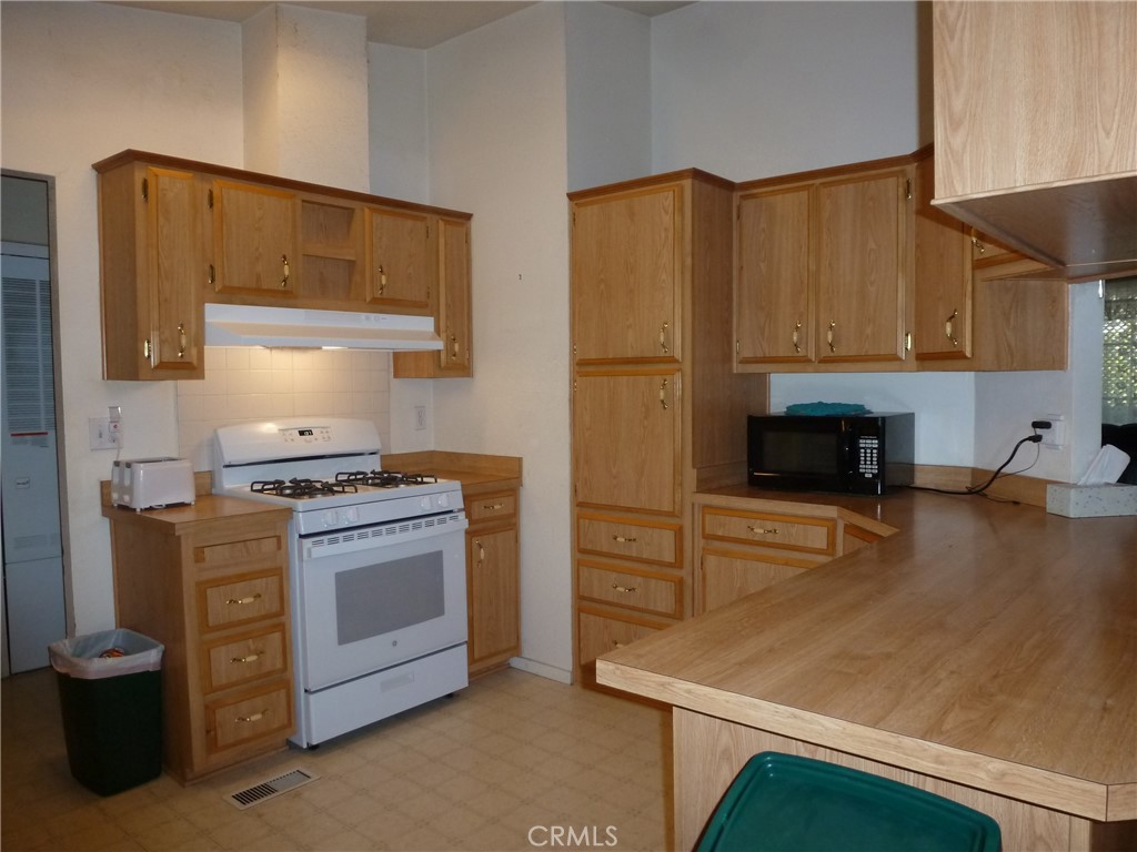 5813 Pacific Heights Road, Unit 103 Oroville, CA 95965 - Photo 2 of 20 a kitchen with stainless steel appliances granite countertop a stove a sink and a refrigerator