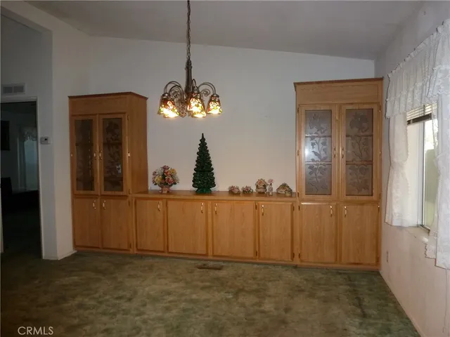 a view of a hallway with chandelier