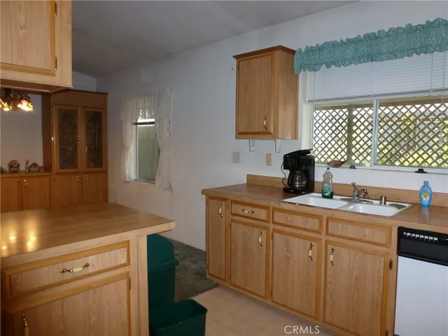 a kitchen with a sink dishwasher and cabinets
