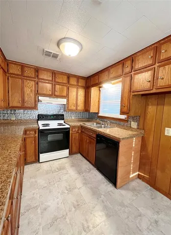 a kitchen with a stove a sink and a microwave