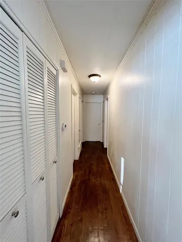 a view of a hallway with a wooden floor