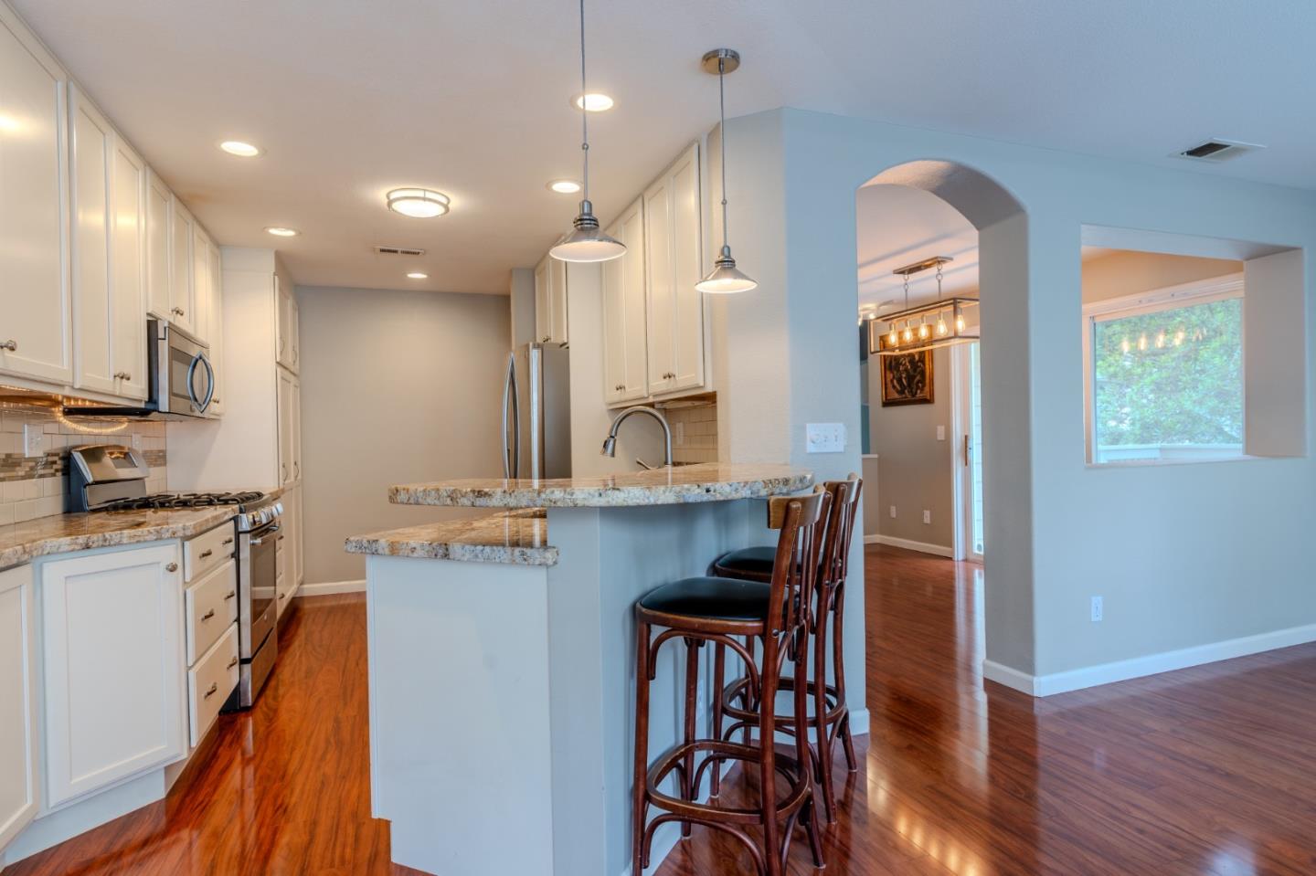 132 Patrick Way Half Moon Bay, CA 94019 - Photo 15 of 29 a kitchen with stainless steel appliances granite countertop sink stove refrigerator and wooden floor