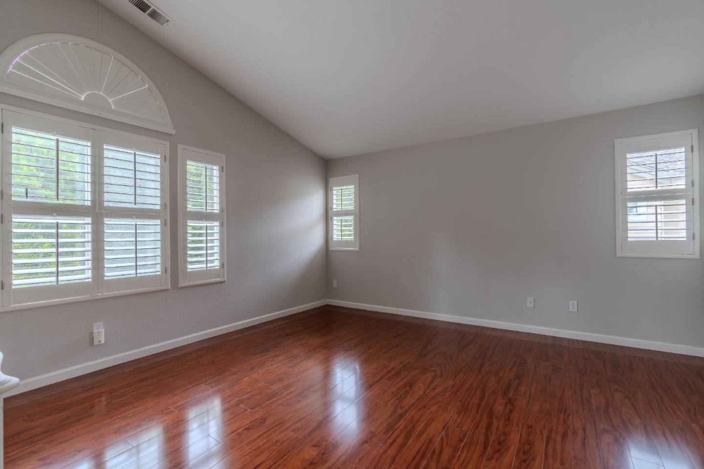 132 Patrick Way Half Moon Bay, CA 94019 - Photo 21 of 29 an empty room with wooden floor and windows